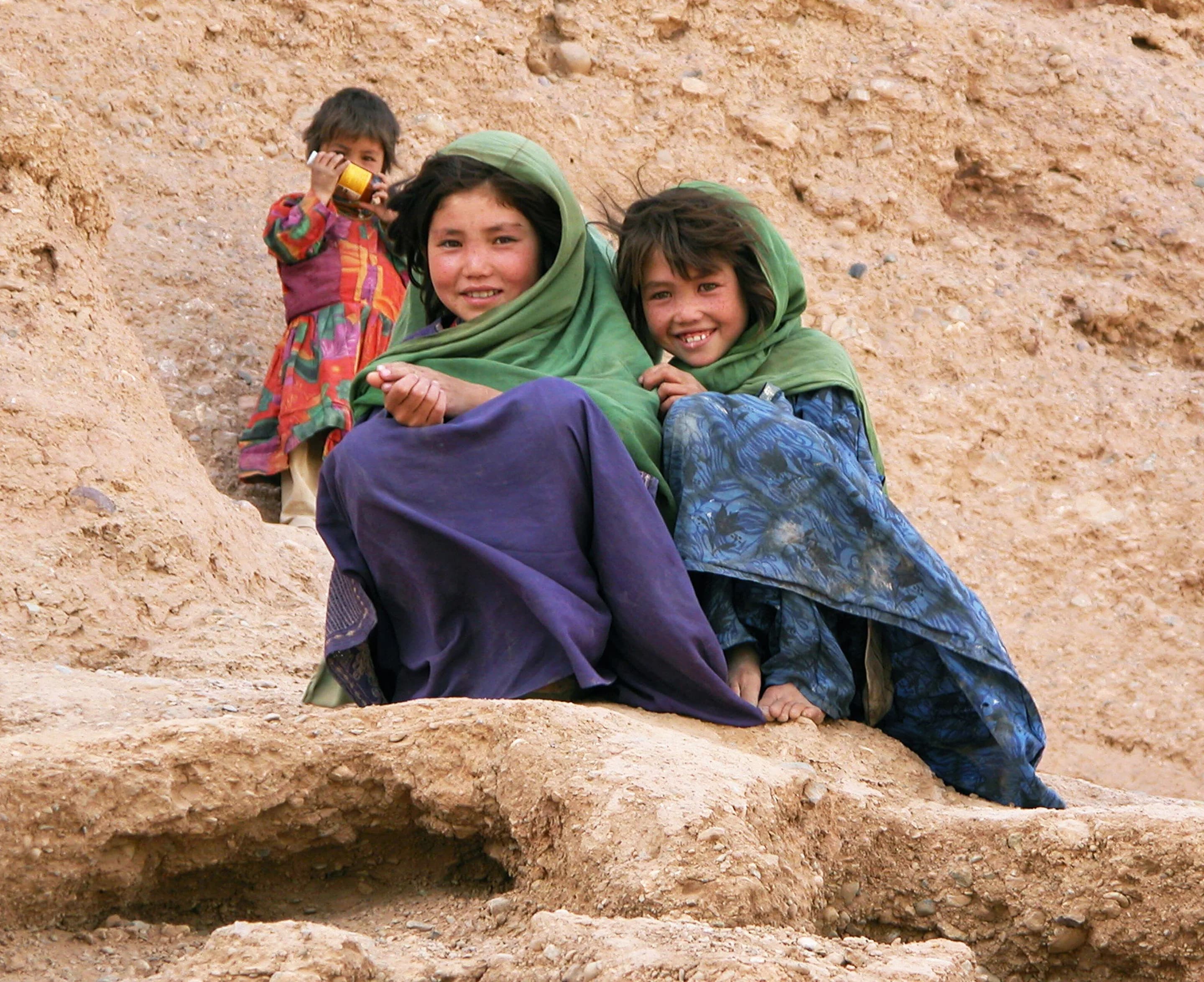 Children sitting together on the rocks at the Bamiyan heritage site