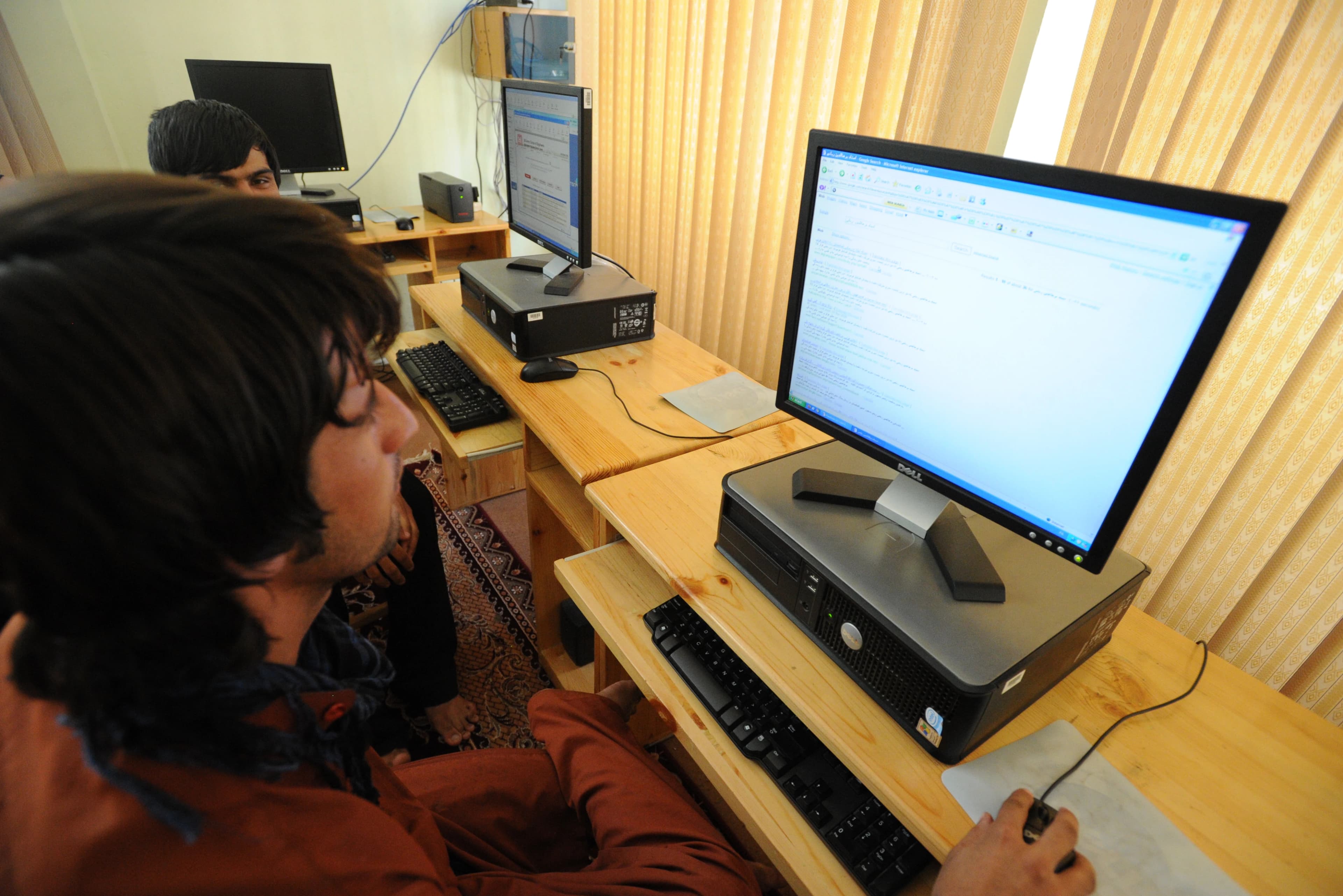 Afghan men using computers at the Lincoln Learning Center in Kunduz, photographed in 2010