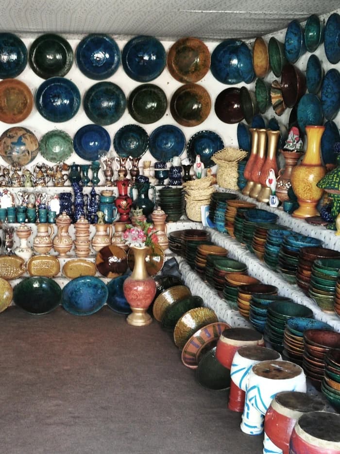 Handmade glazed pottery displayed in a shop in Istalif