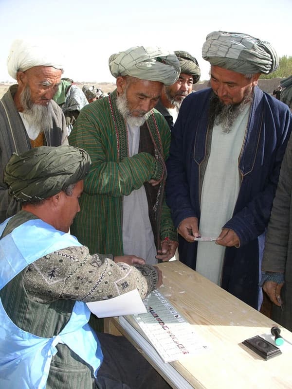 Voters preparing ballots in northern Afghanistan, 2004