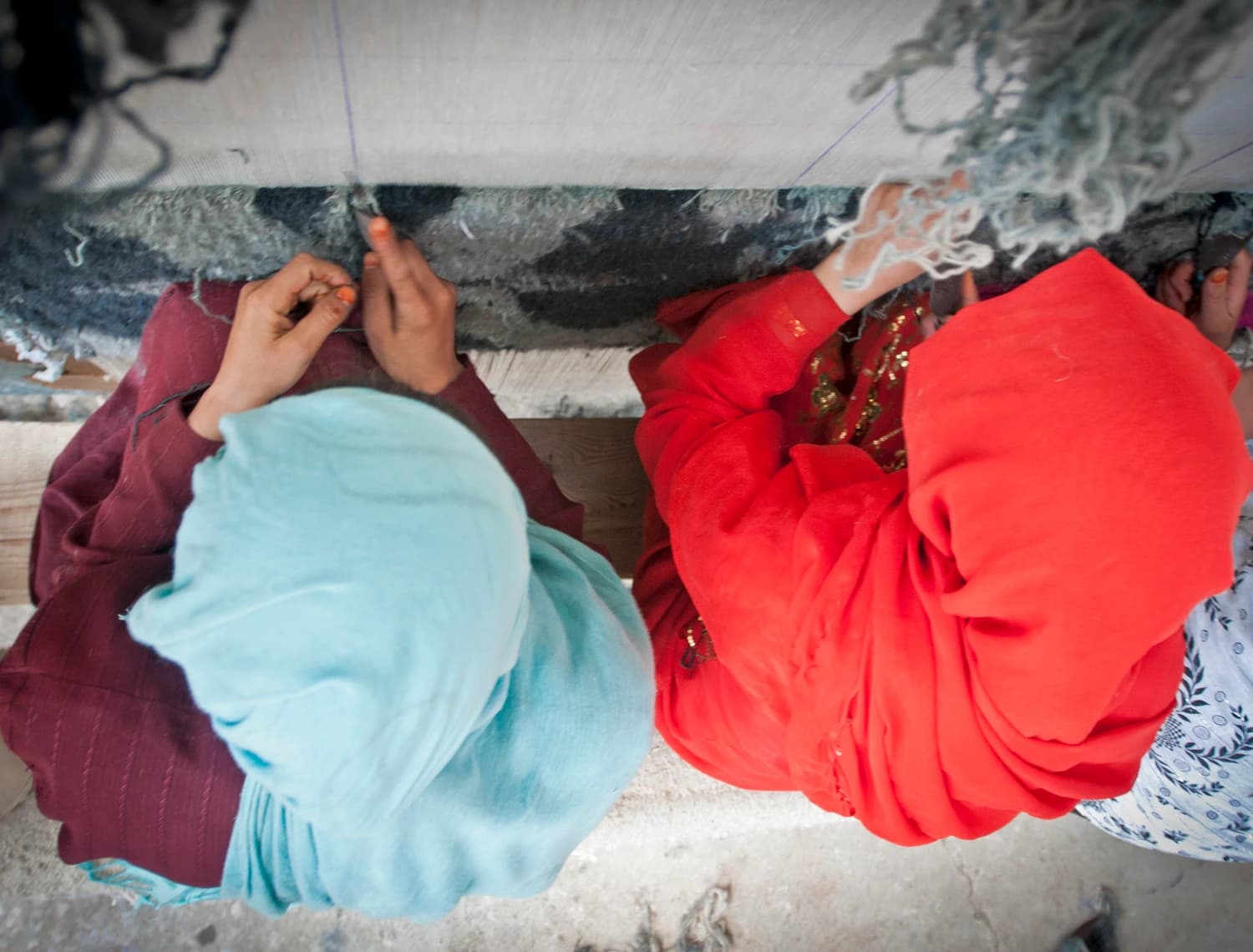 Women weaving carpets at Arzu Studio Hope in Bamyan
