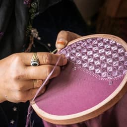 An artisan stitching embroidery in Bamyan