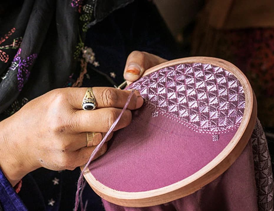 An artisan stitching embroidery in Bamyan