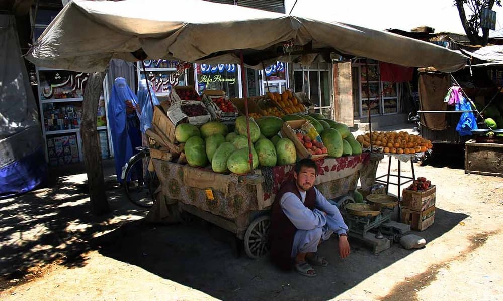 A fruit vendor at a market in Kabul