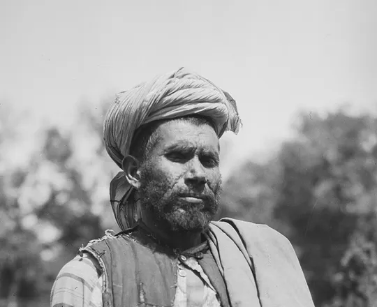A speaker of the Qala-i Shahi dialect of Pashai from the Dara-i-Nur area, in a waistcoat and turban, photographed by Georg Morgenstierne in Peshawar, 1929