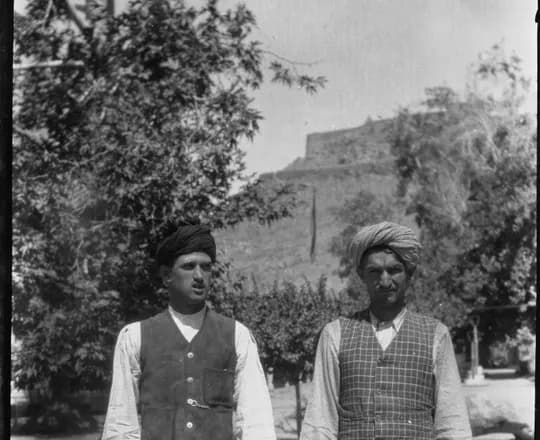 Durr Mahmad from Zhönchigal, Nuristan, a Waigali speaker, beside a Kati companion, both in turbans and waistcoats, Kabul, 1924