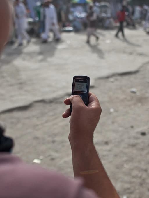 A person using a mobile phone on a Kabul street, photographed in 2010