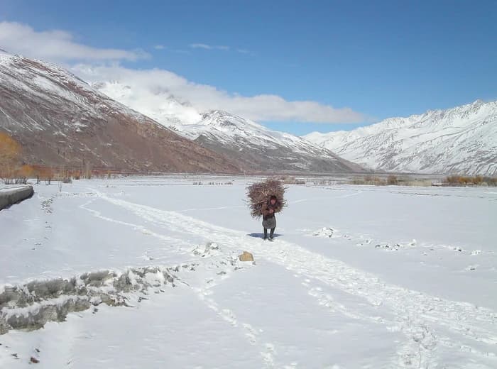 A Wakhi man collecting firewood in the snowy Wakhan Corridor, Badakhshan