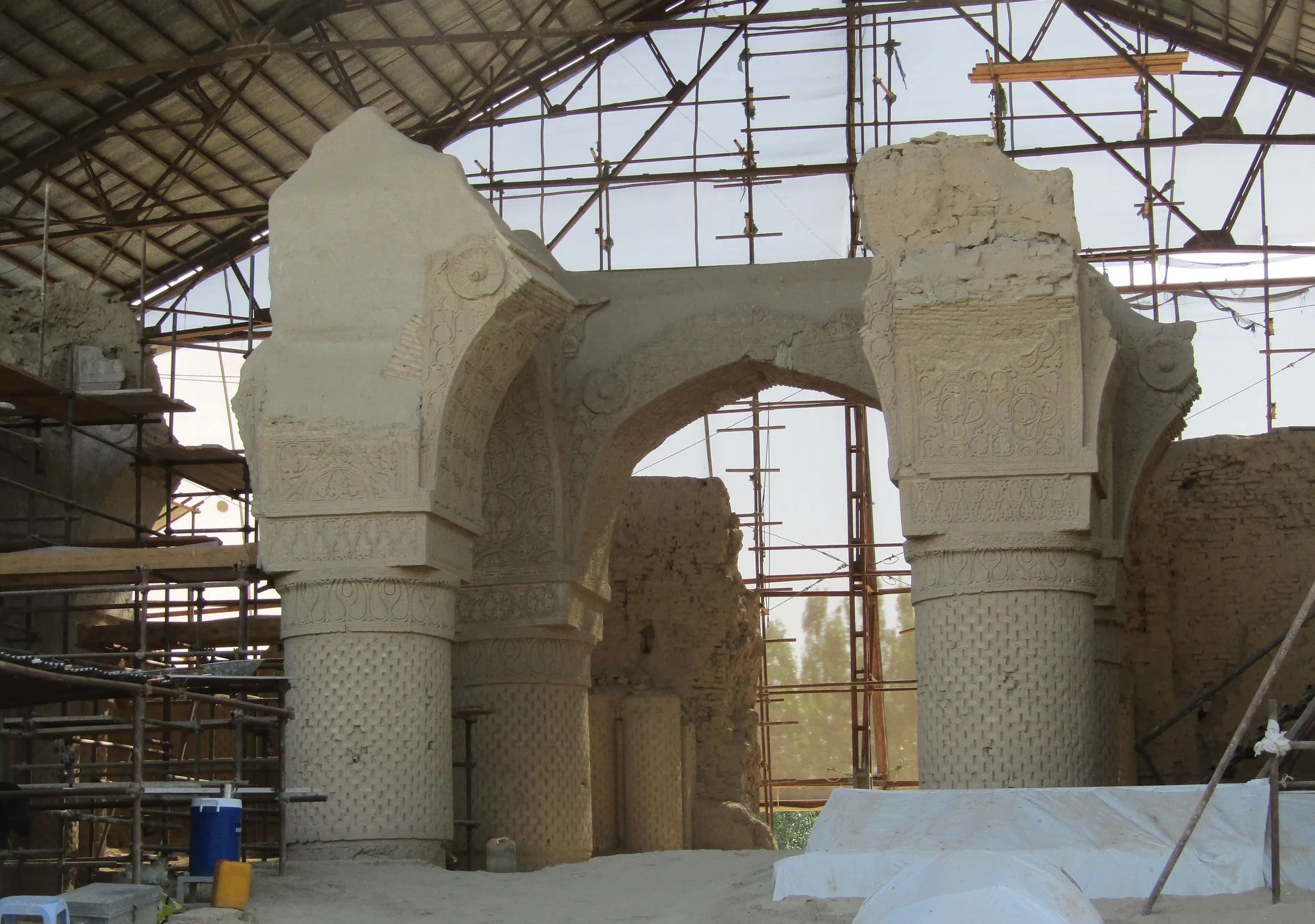 The carved stucco columns and arches of the ninth-century Noh Gonbad (Haji Piyada) mosque in Balkh, under a conservation shelter, 2018