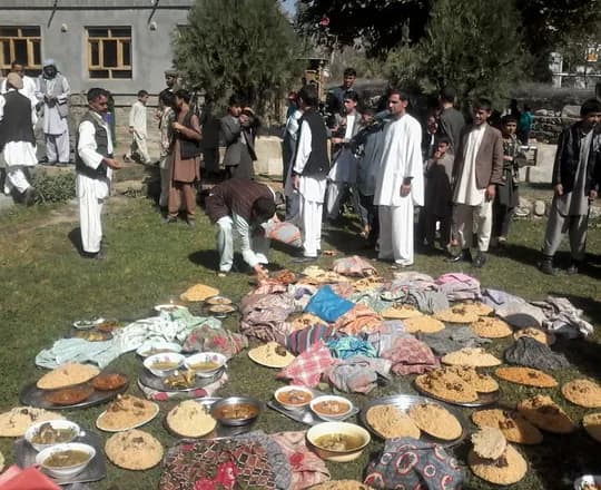 Villagers in festive clothing gathering for Eid al-Adha in Dehbala, Warsaj
