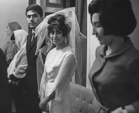 A bride in a white veil and tiara with the groom and guests at a wedding in Kabul, photographed by Herbert Maeder in 1968