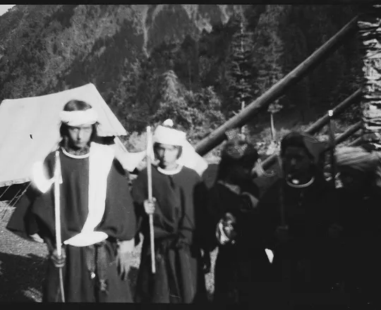 Kati girls in white headbands holding ceremonial dance axes at Brumotul, Bumboret valley, Chitral, 1929