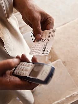 A person holding a mobile phone in Mazar-e-Sharif, photographed in 2010