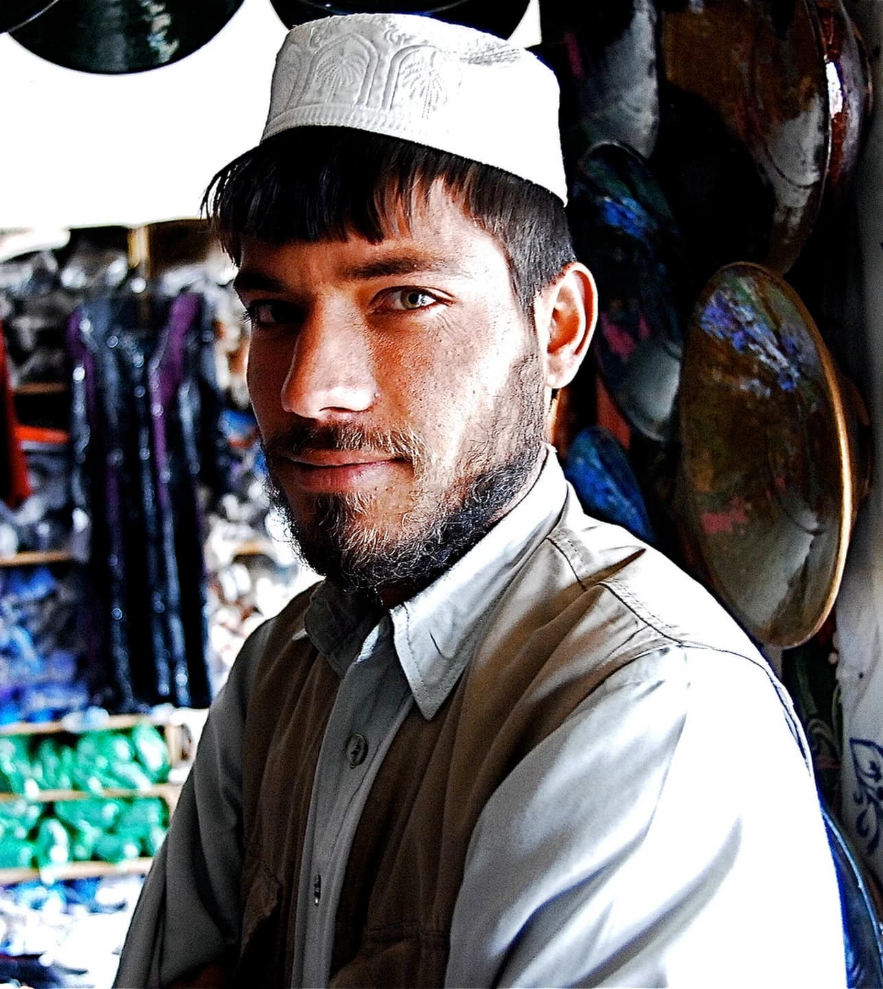 A pottery merchant surrounded by handmade ceramics in Istalif, Afghanistan