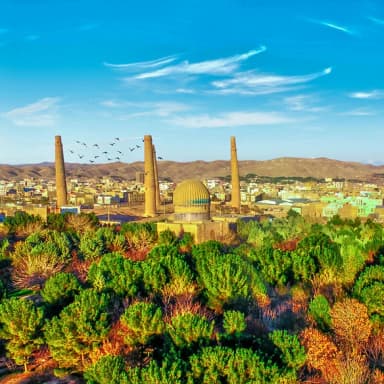 Herat’s historic minarets above green gardens