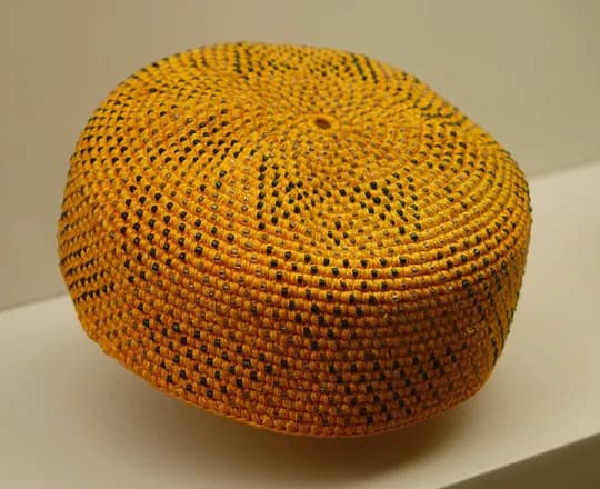 A Nuristani man’s cap knitted in orange wool with glass beads, in the Museo Nacional de Antropología, Madrid