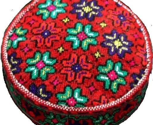 A traditional Wakhi skid cap with red, green and white cross-stitch embroidery