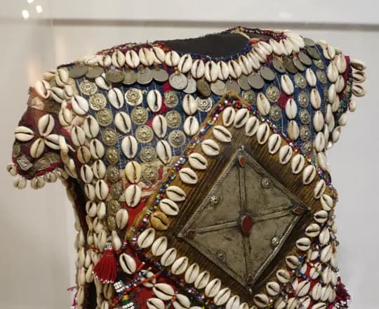 A Yomud Turkmen child’s tunic from northern Afghanistan decorated with cowrie shells and beads, early to mid 20th century