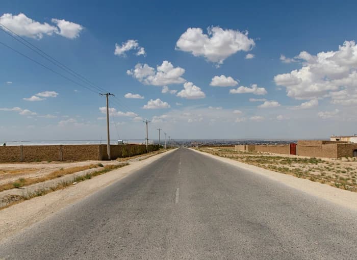 A road toward Mazar-e-Sharif beneath a cloudy sky