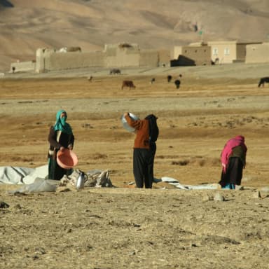 Women walking through farmland in Afghanistan