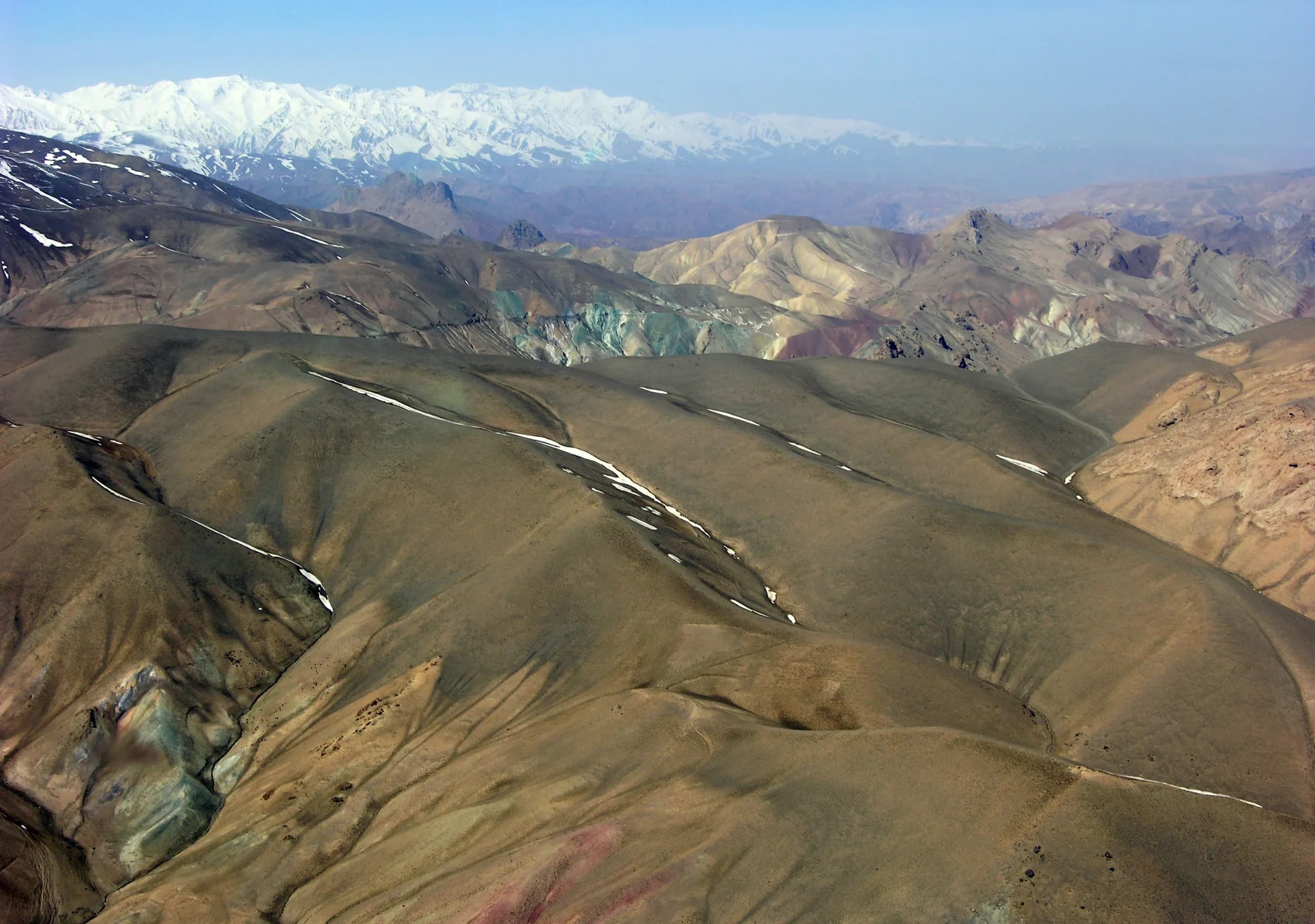 Colorful mineral-streaked mountains in Sar-e Pol, seen from the air