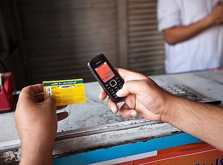 Topping up a mobile phone with prepaid airtime in Kabul, photographed in 2010