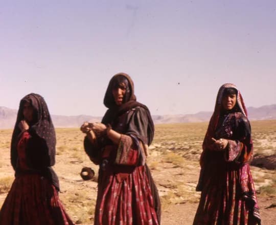 Nomadic Afghan women wearing traditional long dresses
