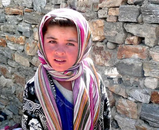 A girl in a long patterned headscarf at the cross-border market in Ishkashim, Badakhshan, 2009