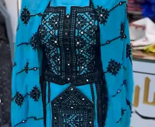A Baloch dress with black siah dozi needlework across the front
