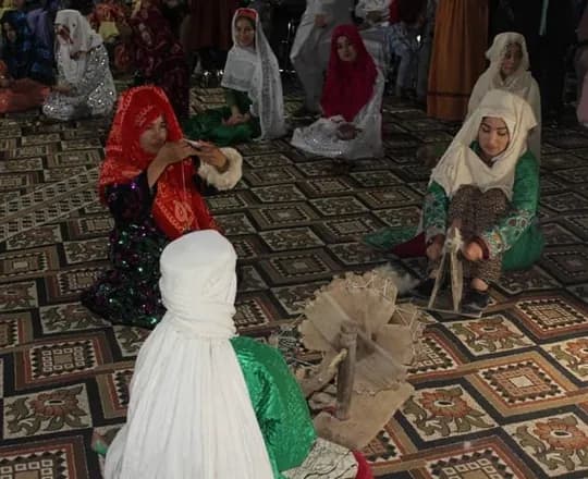 Women and girls in colorful dresses and scarves at an Uzbek cultural gathering in Afghanistan