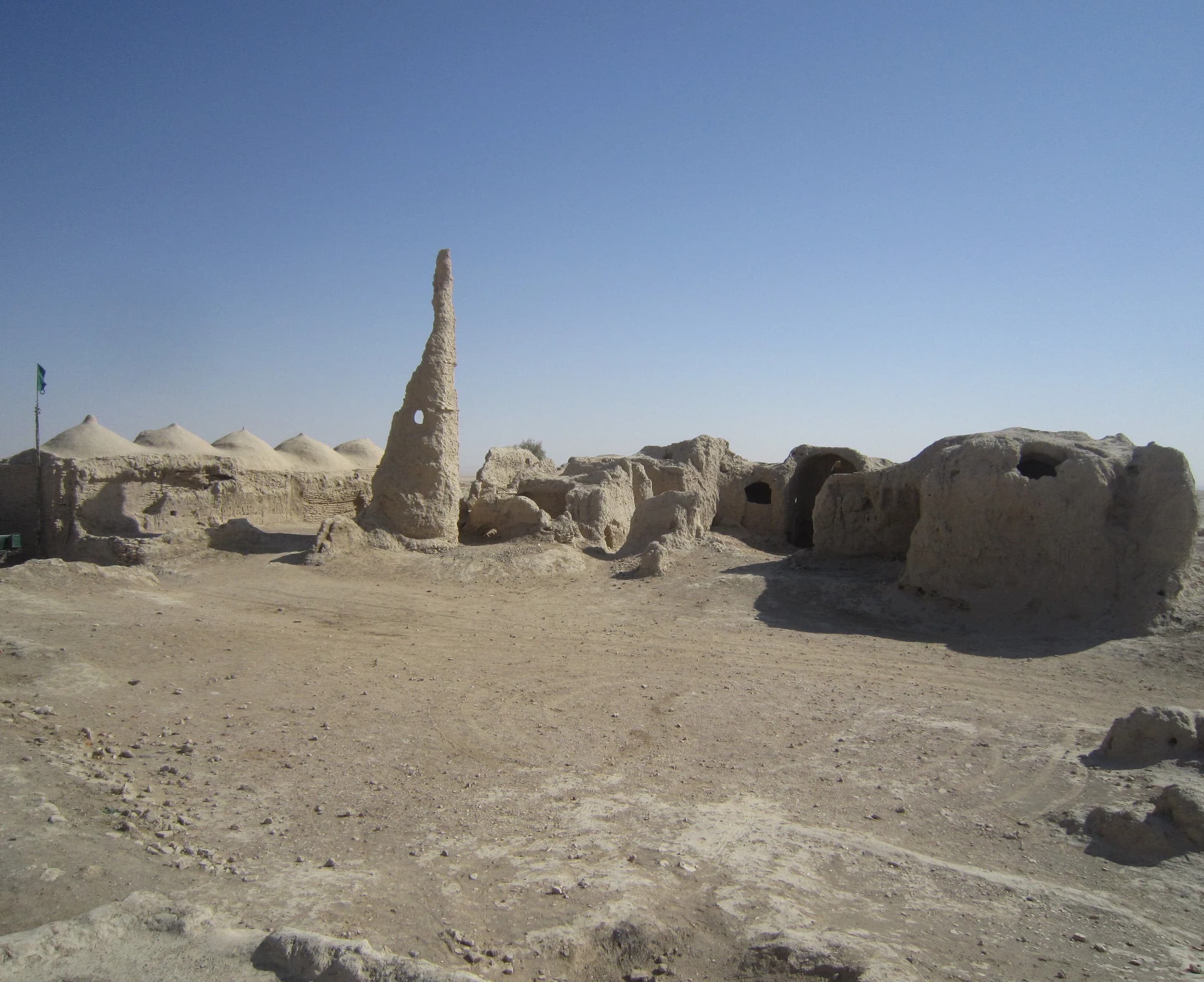 Mud-brick ruins and a tall tower at a historic fort in Nimroz Province