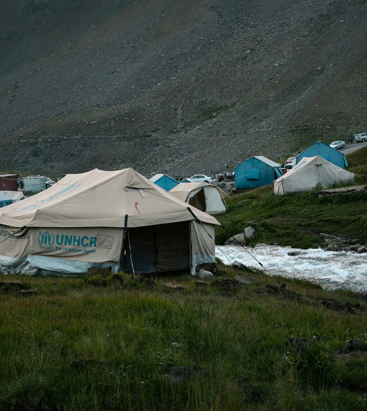 Camping tents beside a mountain river in Paryan, Afghanistan
