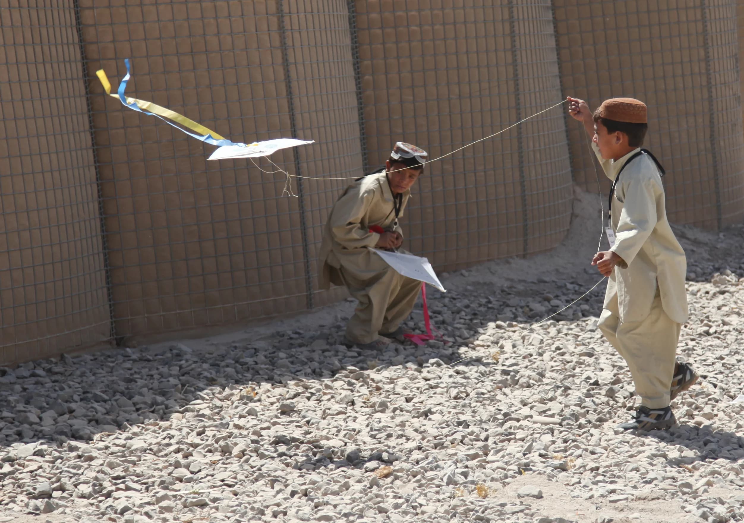 Children playing with a kite in a Kandahar village