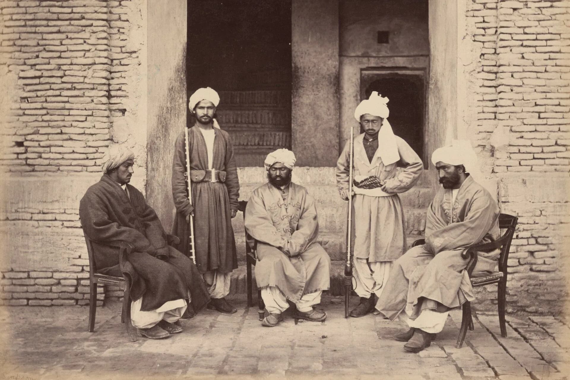 A group of Taimuri men photographed in a palace courtyard in Kandahar, about 1880