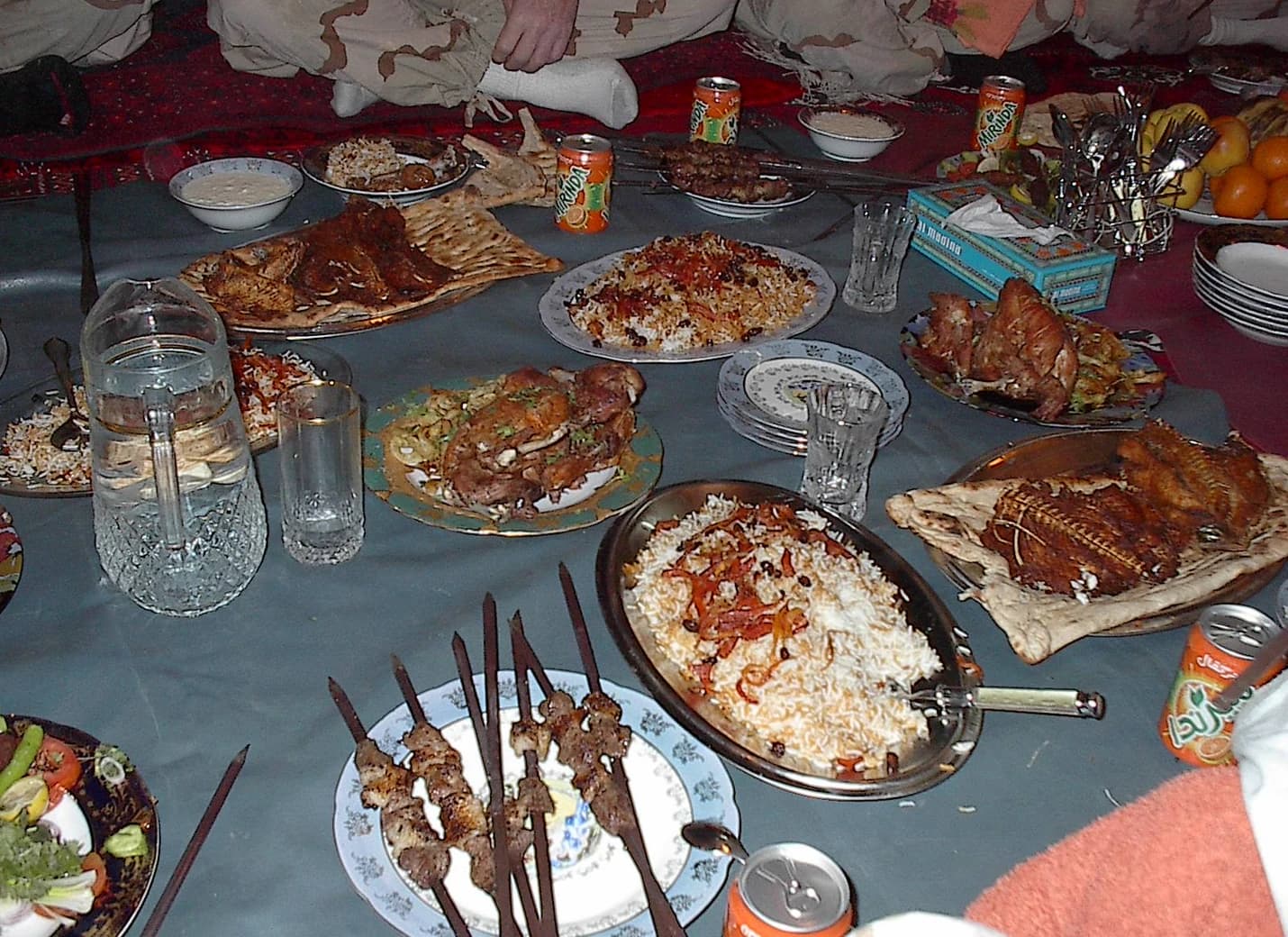 An Afghan dinner laid out with shared dishes and glasses
