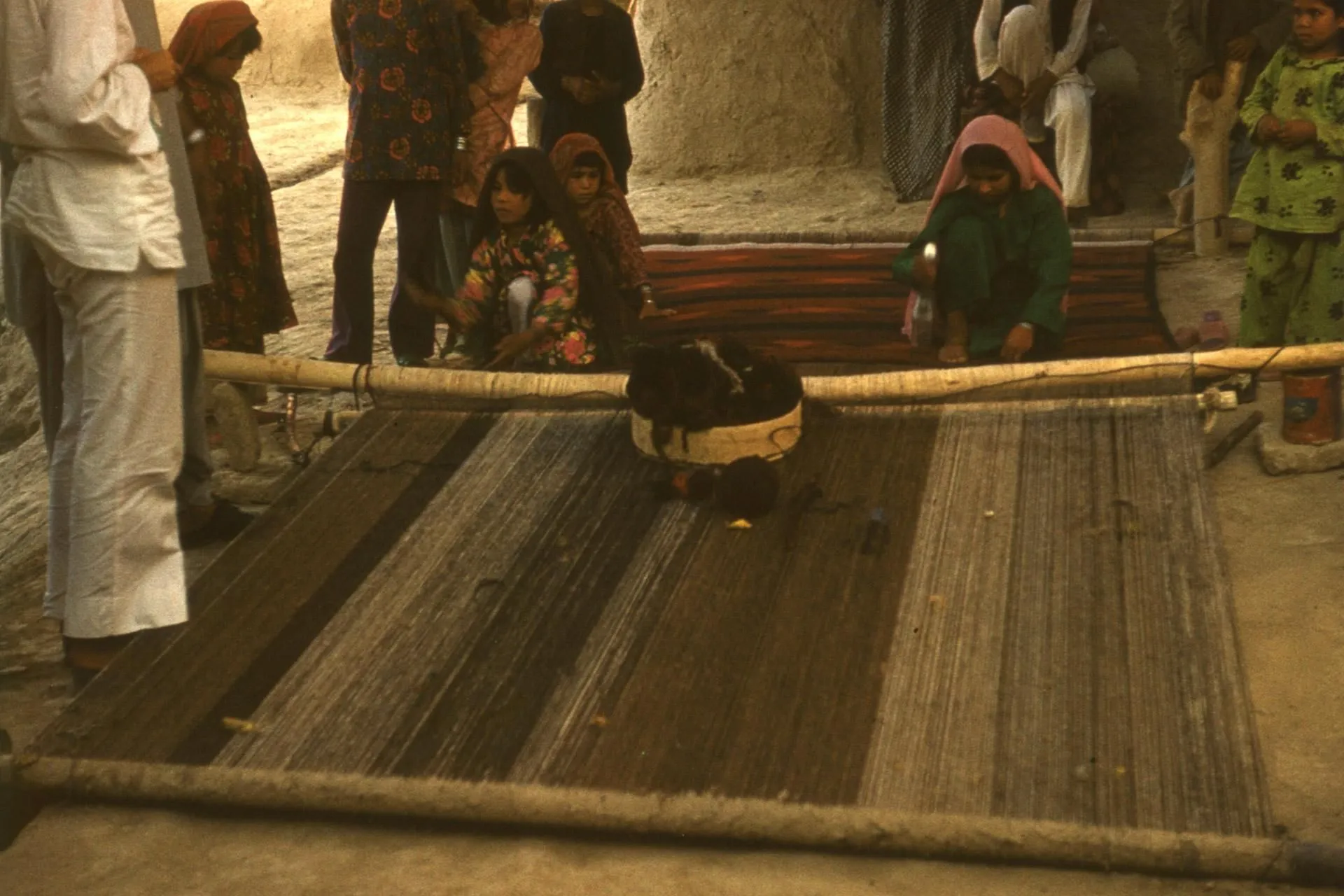 Turkmen girls weaving a kilim on a floor loom in Dawlatabad, Balkh, 1976