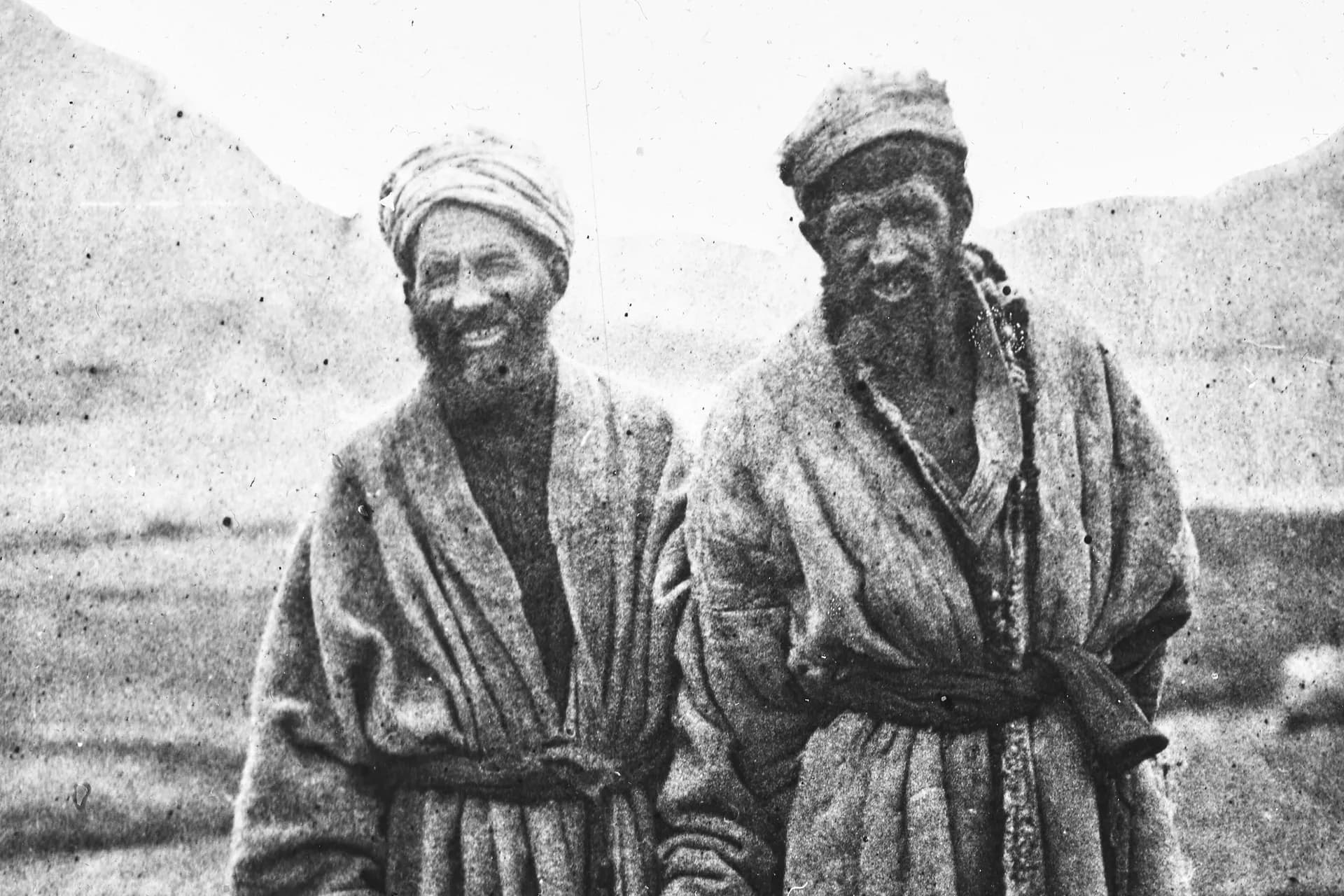 Two Wakhi men in long quilted robes and wrapped headcloths at Sarhad, Wakhan, photographed by Guillaume Capus in 1887