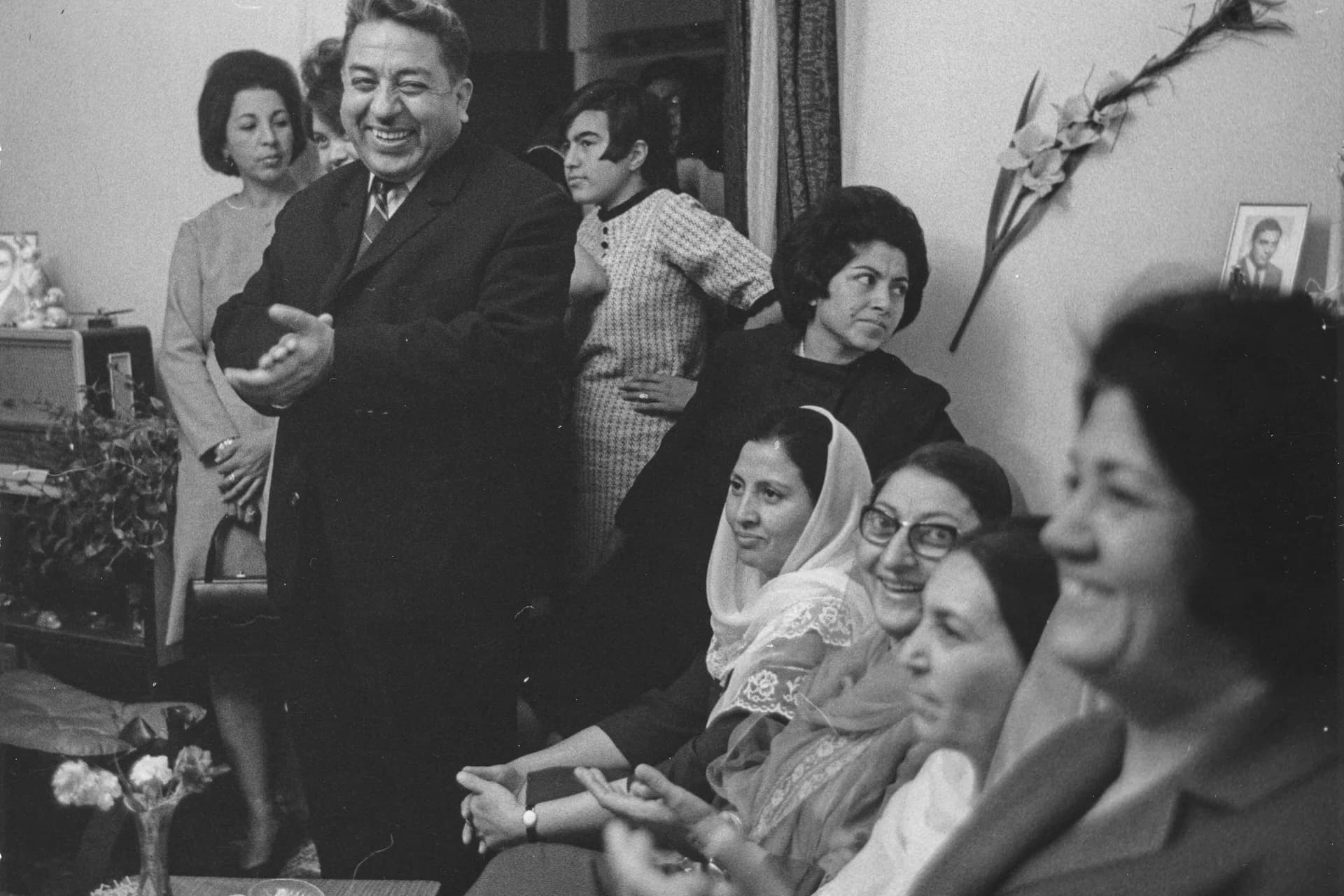 Guests celebrating together in the living room of a family home during a wedding in Kabul, photographed by Herbert Maeder in 1968