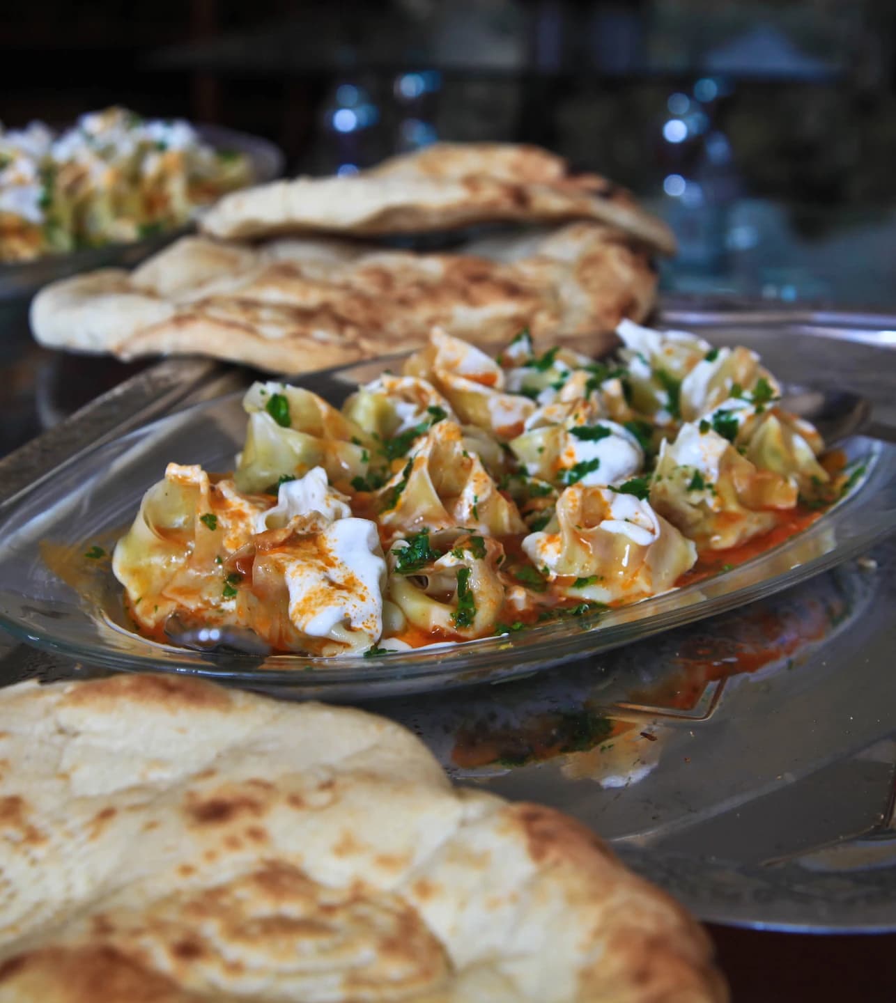 Afghan mantu dumplings topped with sauce