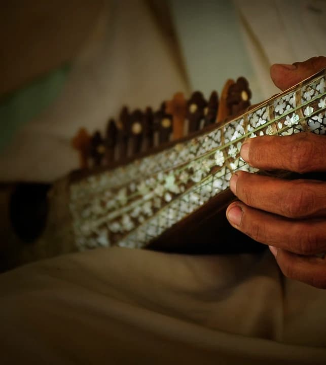 Hands playing an Afghan rubab at the Anab Gull Poetry Festival in Farah in 2010