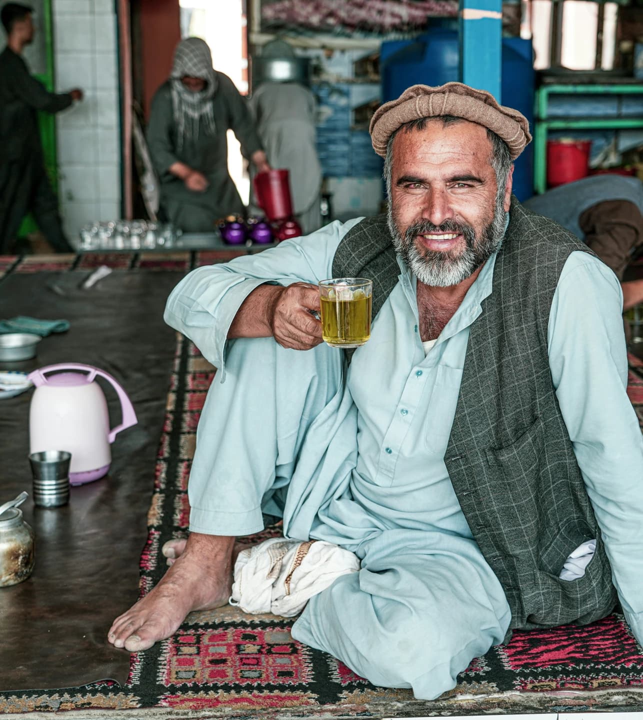 An Afghan man enjoying a glass of tea